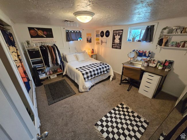 Bedroom featuring visible vents, a textured ceiling, and carpet | Image 39