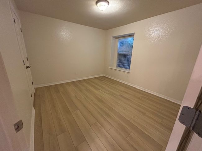 Unfurnished bedroom featuring light wood-style floors and baseboards | Image 18
