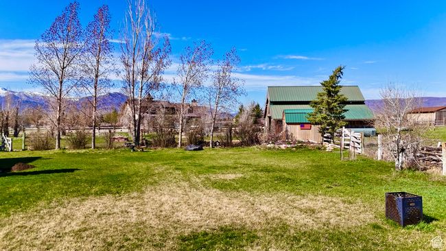 View of yard featuring an outbuilding, a mountain view, and an outdoor structure | Image 18