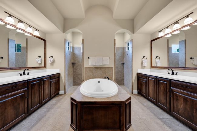 Bathroom with walk in shower, two vanities, and a jetted tub | Image 19