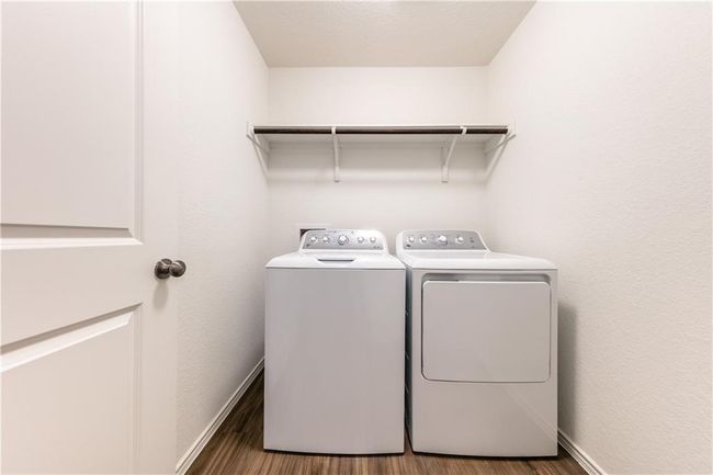 Laundry area with washer and clothes dryer and wood finished floors | Image 10