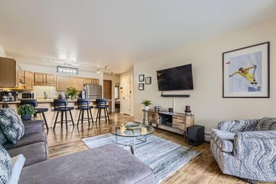 Lots of space in this living room! Current owner set the breakfast bar as the dining area seating, and there would be plenty of room to add a dining table as well. | Image 2