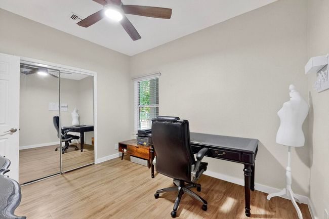 Office featuring light wood-type flooring and a ceiling fan | Image 23