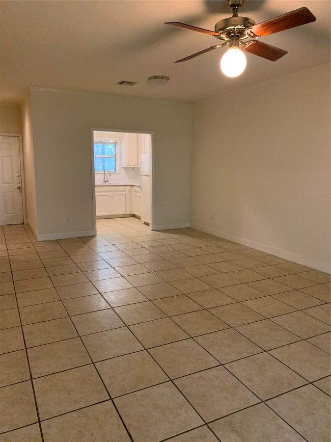 Spare room featuring a sink, baseboards, visible vents, ceiling fan, and light tile patterned floors | Image 8