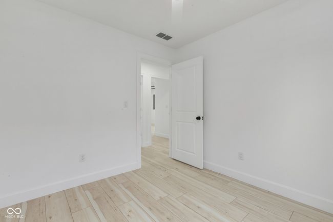 unfurnished room featuring visible vents, baseboards, and wood finished floors | Image 38