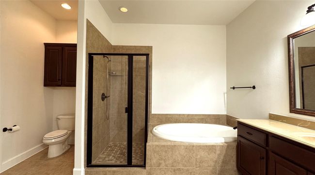 Full bath with a bath, vanity, a stall shower, tile patterned flooring, and recessed lighting | Image 6