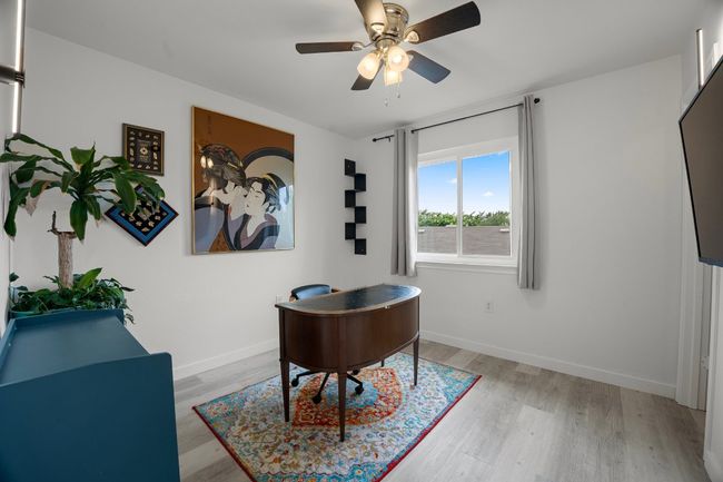 Office featuring light wood-type flooring and a ceiling fan | Image 25