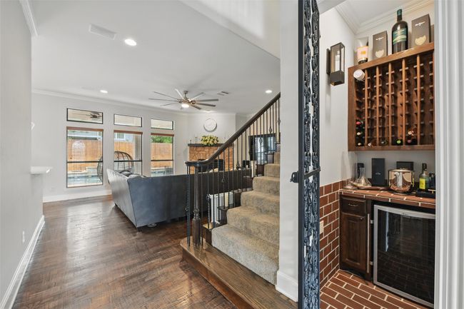 Wine room features an ornate door, counter space and decorate lighting. | Image 8