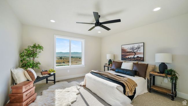 Bedroom featuring light colored carpet, recessed lighting, and a ceiling fan | Image 18