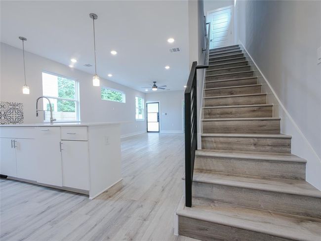 Stairway featuring wood finished floors, ceiling fan, and recessed lighting | Image 13