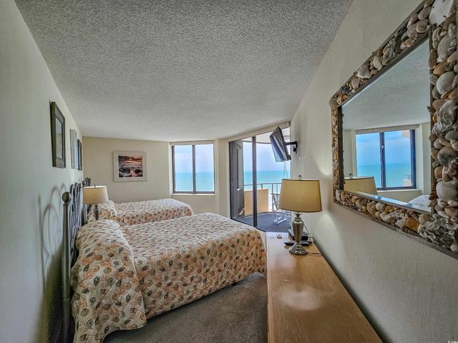 Carpeted bedroom featuring access to outside and a textured ceiling | Image 27