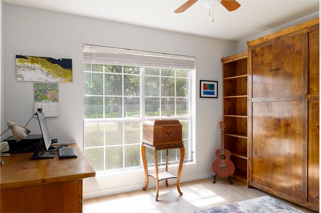 Office space with ceiling fan and light wood finished floors | Image 18