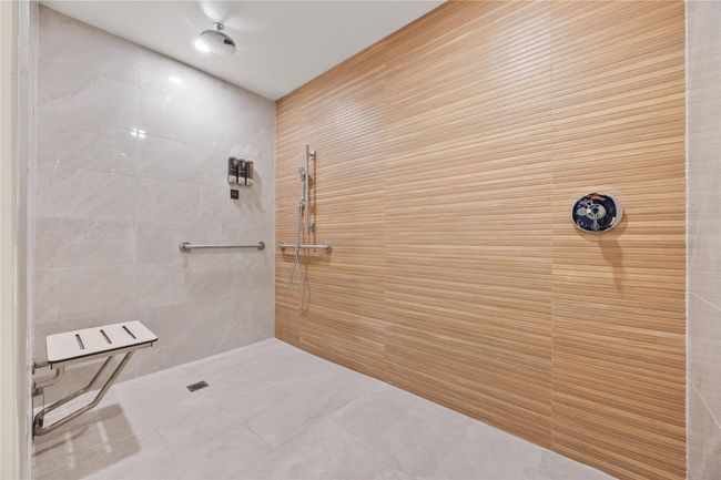 Bathroom featuring tile patterned floors and a tile shower | Image 16
