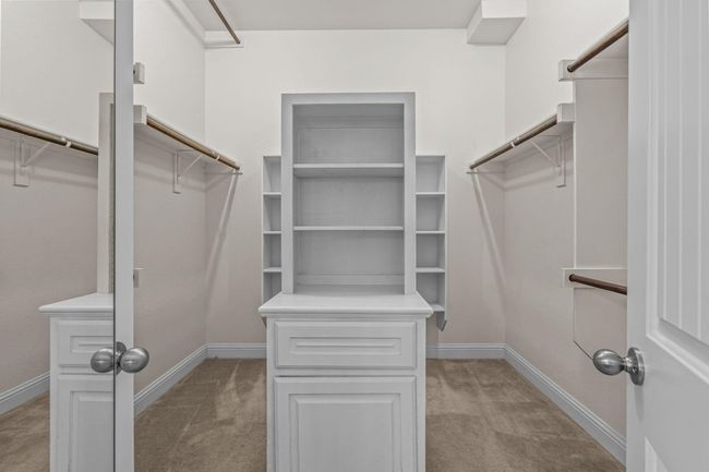 Walk in closet with light carpet | Image 20