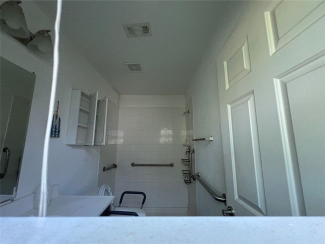 Bathroom with a tile shower and vanity | Image 15
