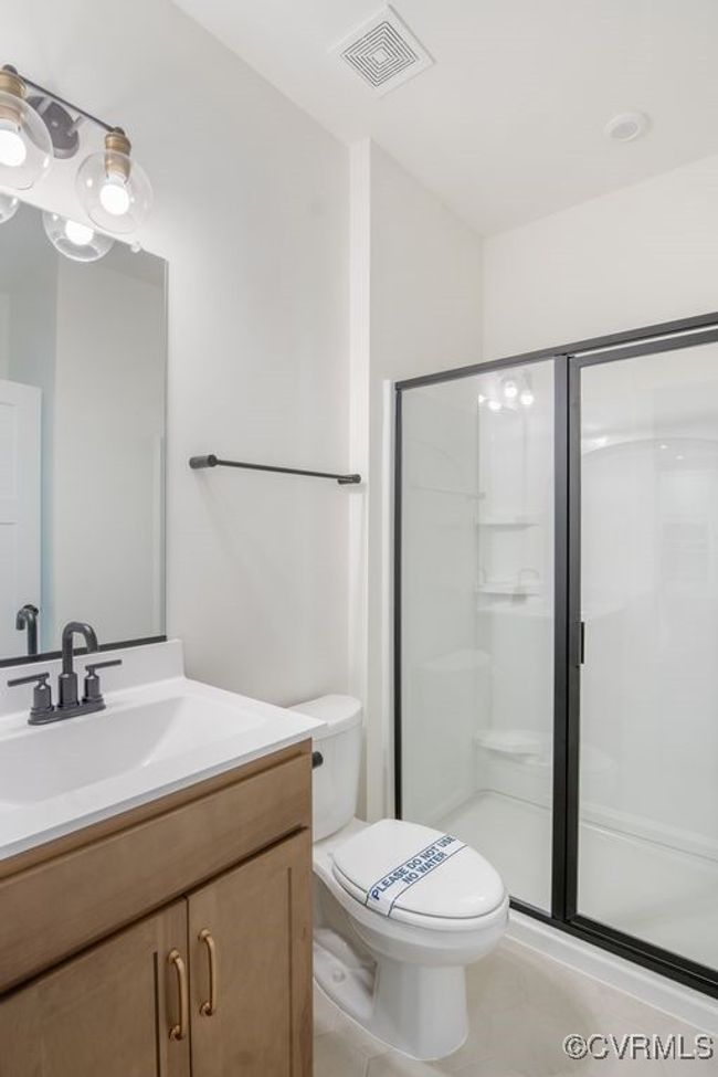 Photo represents the plan, not the actual home. Design selections may vary. A guest suite with ensuite bath completes the first floor. | Image 22