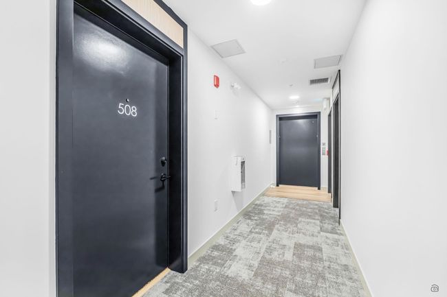 Corridor featuring elevator, carpet, visible vents, and baseboards | Image 21