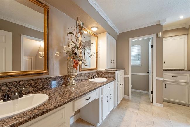 Beautifully redone primary bath has double sinks plus knee space and a private water closet. | Image 18