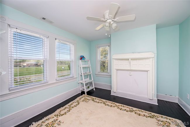 Unfurnished bedroom with baseboards, a ceiling fan, visible vents, and hardwood / wood-style flooring | Image 20
