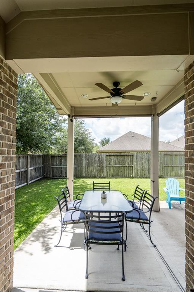 Nice size covered back patio with new ceiling fans. | Image 29