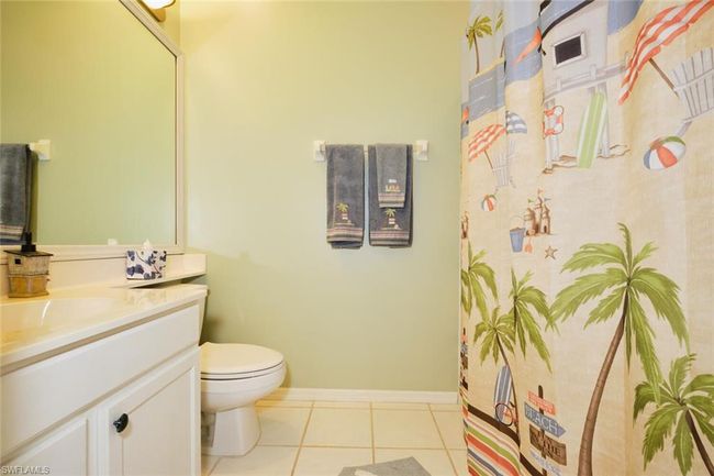 Bathroom with toilet, tile patterned flooring, and vanity | Image 46
