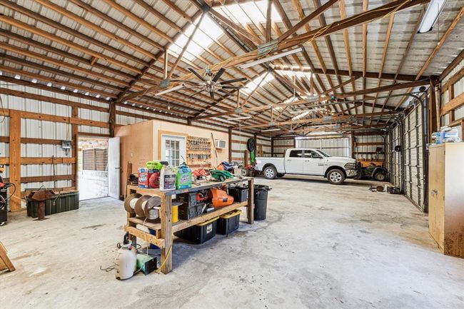 There are 2 entry doors, 3 commercial grade overhead doors and 2 sliding doors for convenience and easy access. There is even a bonus hobby room with AC unit | Image 38