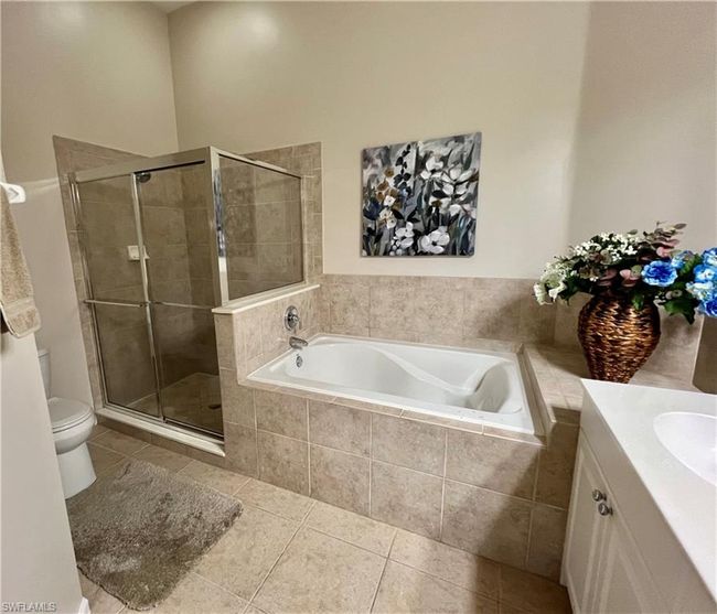 Large tub and separate shower primary bath before accessories removed | Image 23