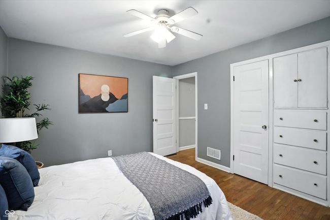 bedroom with wood finished floors and ceiling fan | Image 25