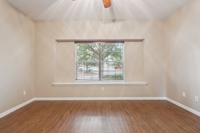 Unfurnished room with baseboards, wood finished floors, and a ceiling fan | Image 20