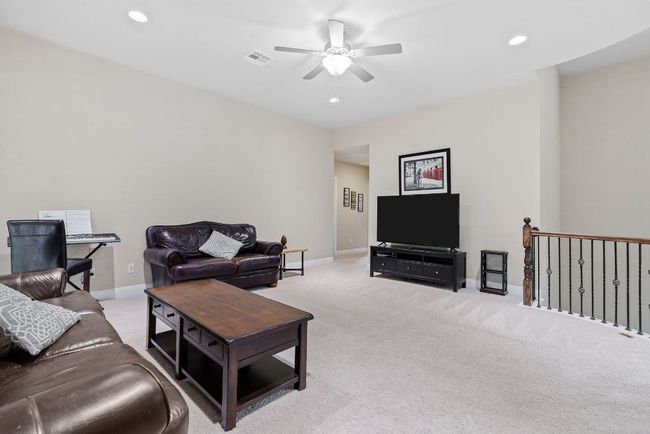 Living room with a ceiling fan, light colored carpet, baseboards, and recessed lighting | Image 24