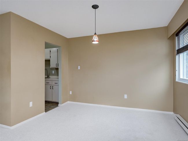 Empty room with a baseboard radiator and carpet flooring | Image 6