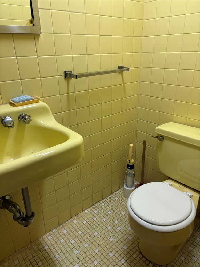 Bathroom with toilet, tile patterned flooring, and tile walls | Image 12