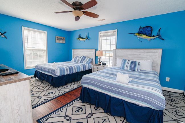 Bedroom featuring a ceiling fan, a textured ceiling, and baseboards | Image 34