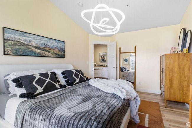Bedroom featuring baseboards, a chandelier, and light wood-style floors | Image 18