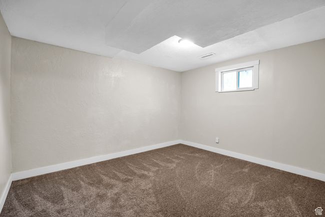 Spare room with dark carpet, baseboards, and visible vents | Image 23