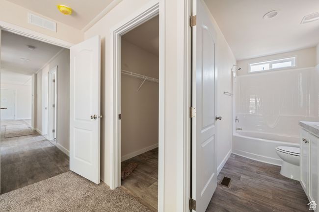 Hall featuring dark wood-type flooring and baseboards | Image 9