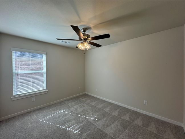 Escape to the cozy comfort of the secondary bedroom, a peaceful retreat with ample space to personalize and create your own haven. | Image 19