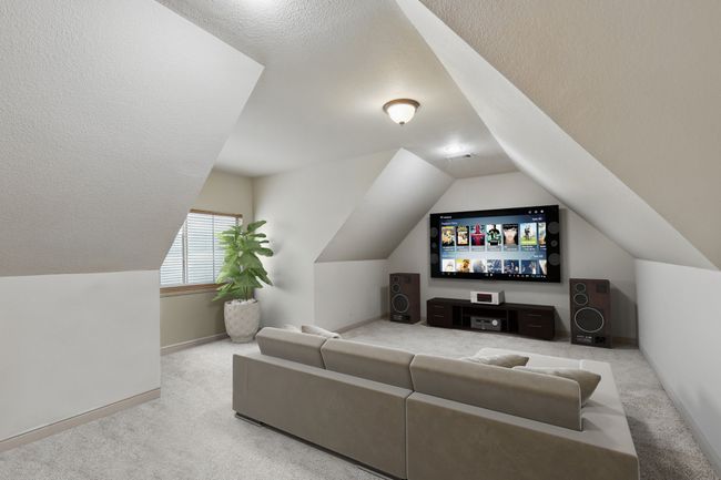 Carpeted cinema featuring lofted ceiling and a textured ceiling | Image 23