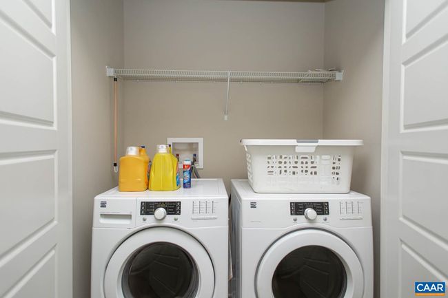In the hall, you'll find a large laundry closet. | Image 28
