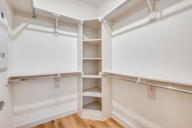 Spacious closet featuring light wood-style floors | Image 5