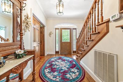 Foyer entrance with a healthy amount of sunlight, light wood-type flooring, and ornamental molding | Image 3