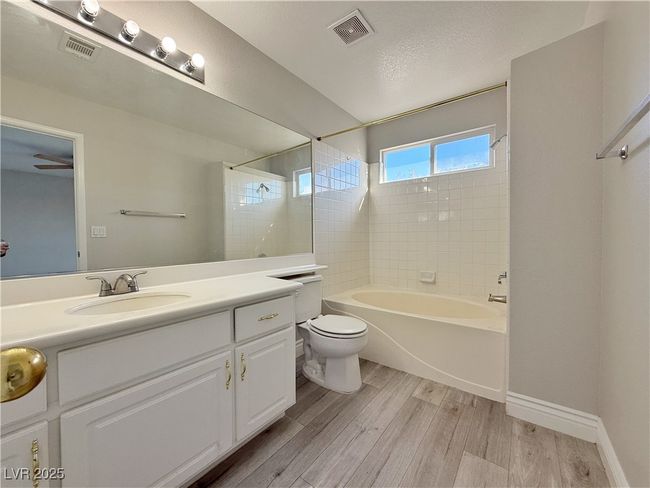 Full bath with visible vents, toilet, vanity, and wood finished floors | Image 31