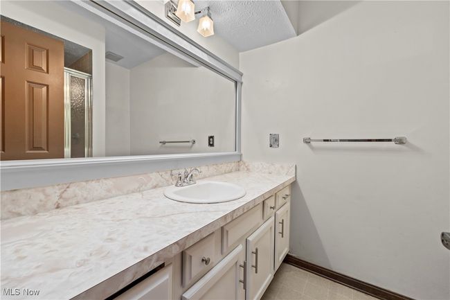 Bathroom with vanity, a shower stall, and a textured ceiling | Image 21