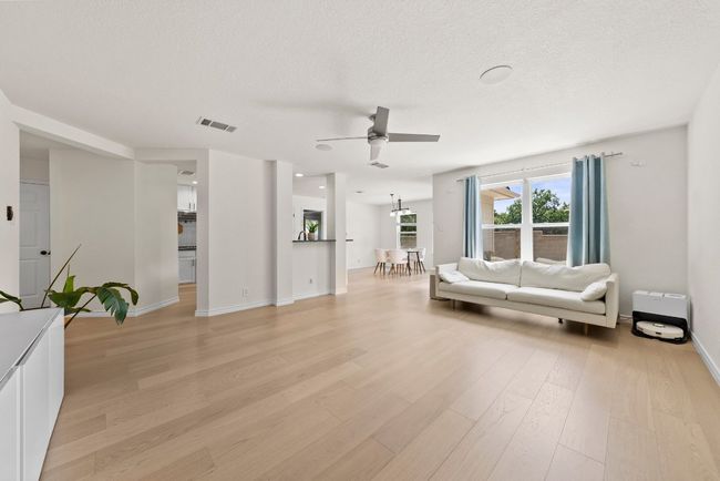 Amazing view of new flooring in living, kitchen, dining areas | Image 11