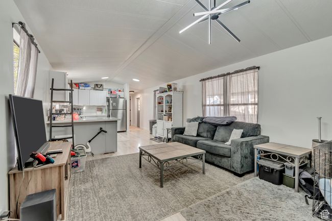 Living room featuring lofted ceiling with beams | Image 7