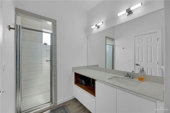 Bathroom featuring hardwood / wood-style flooring, vanity, and an enclosed shower | Image 17