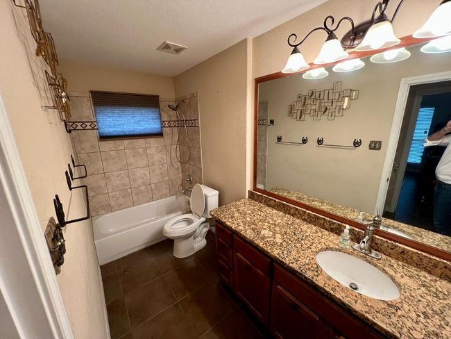 Full bathroom with shower / bathtub combination, tile patterned flooring, and vanity | Image 14