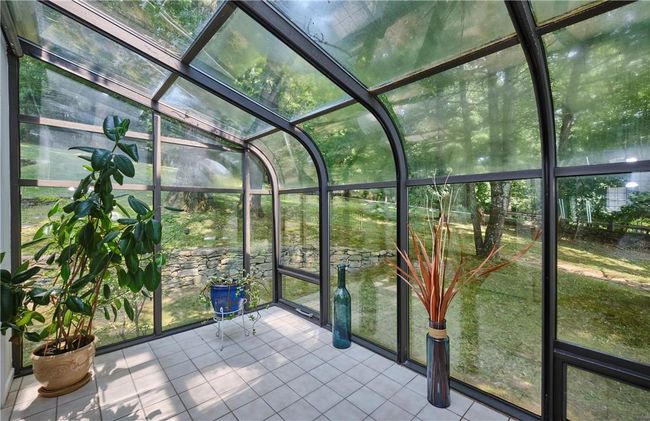 Unfurnished sunroom featuring a wealth of natural light | Image 9