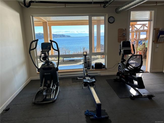 Workout area with plenty of natural light and a water view | Image 44