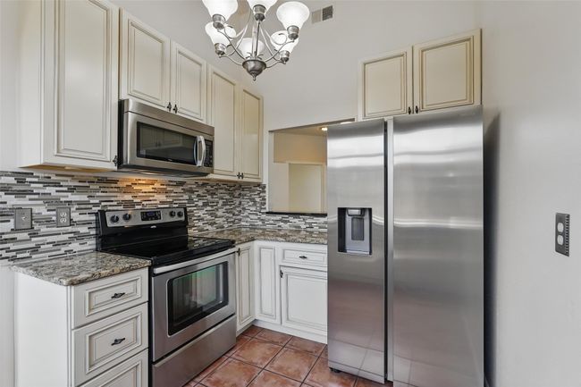 Kitchen with stainless steel appliances and tile floors | Image 6